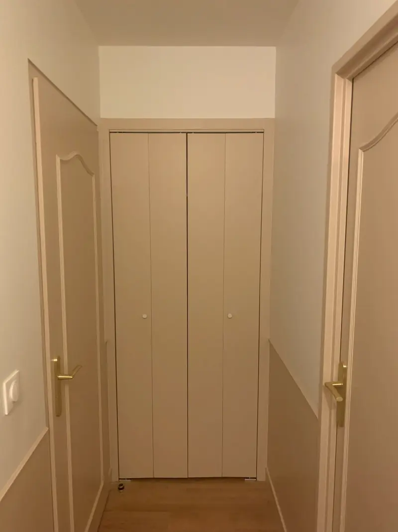 Placard sur mesure avec portes pliantes au fond du couloir